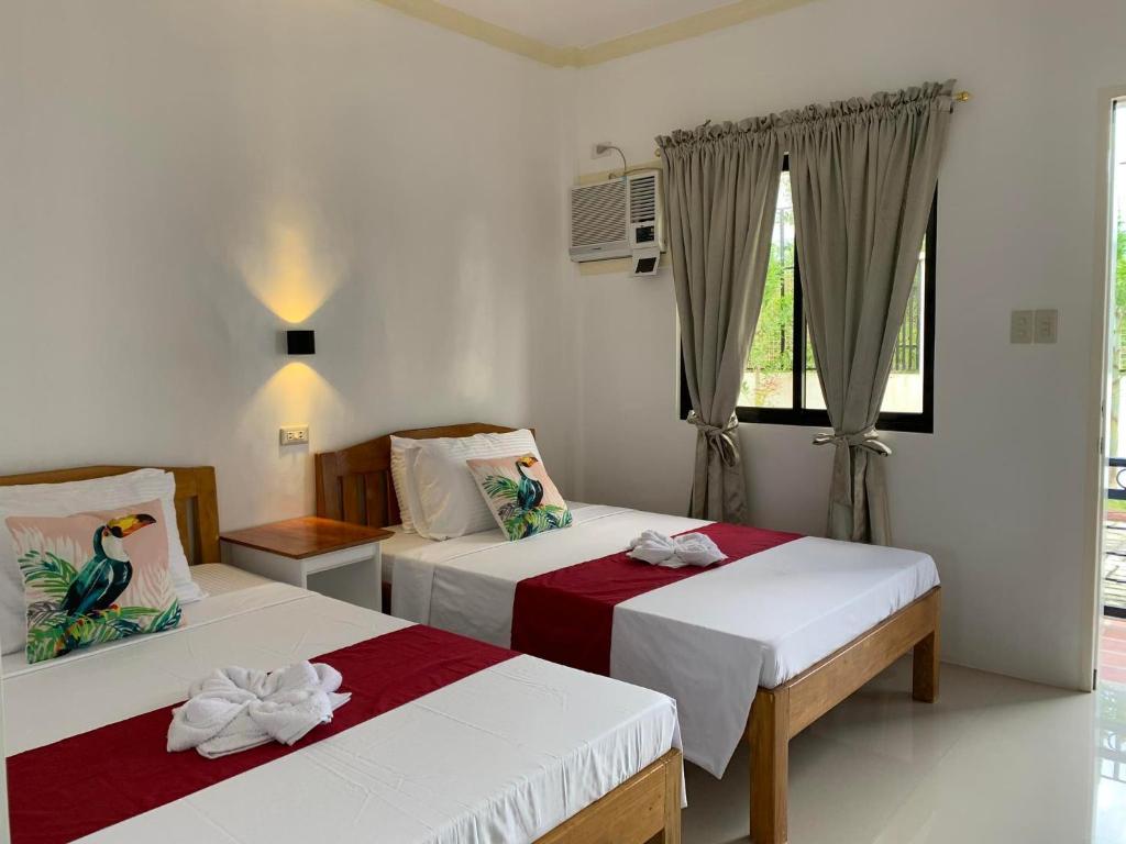 Postel nebo postele na pokoji v ubytování Sunshine Stay Panglao
