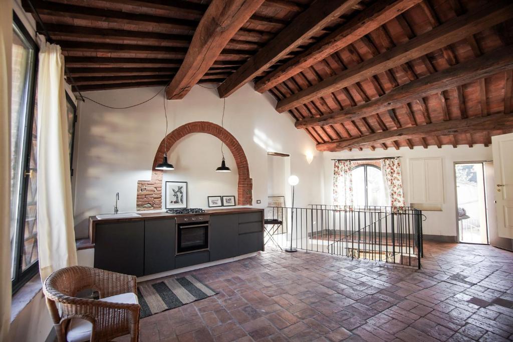 a large room with a kitchen and a living room at La Fabbrica in Calci