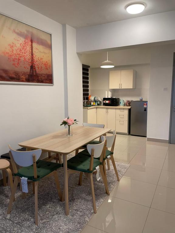 eine Küche mit einem Holztisch und Stühlen im Zimmer in der Unterkunft AZ Stayz Homestay in Kajang