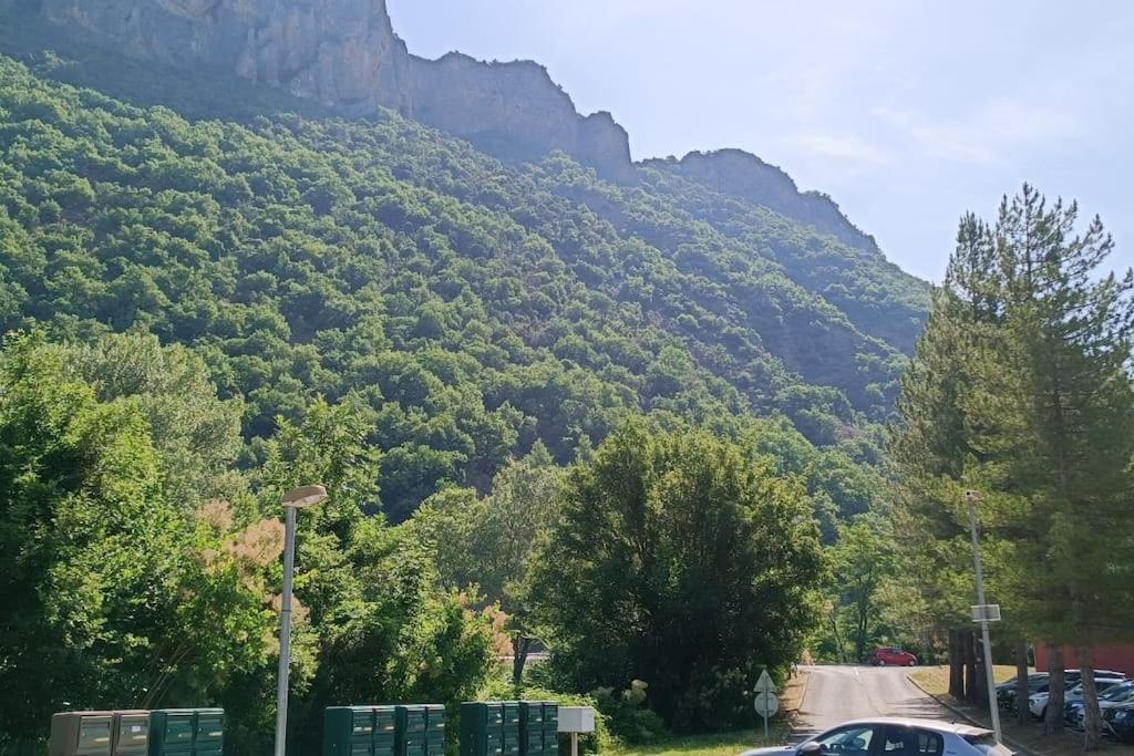 a mountain with cars parked on the side of a road at T2 au cœur de la nature de Digne in Digne-les-Bains