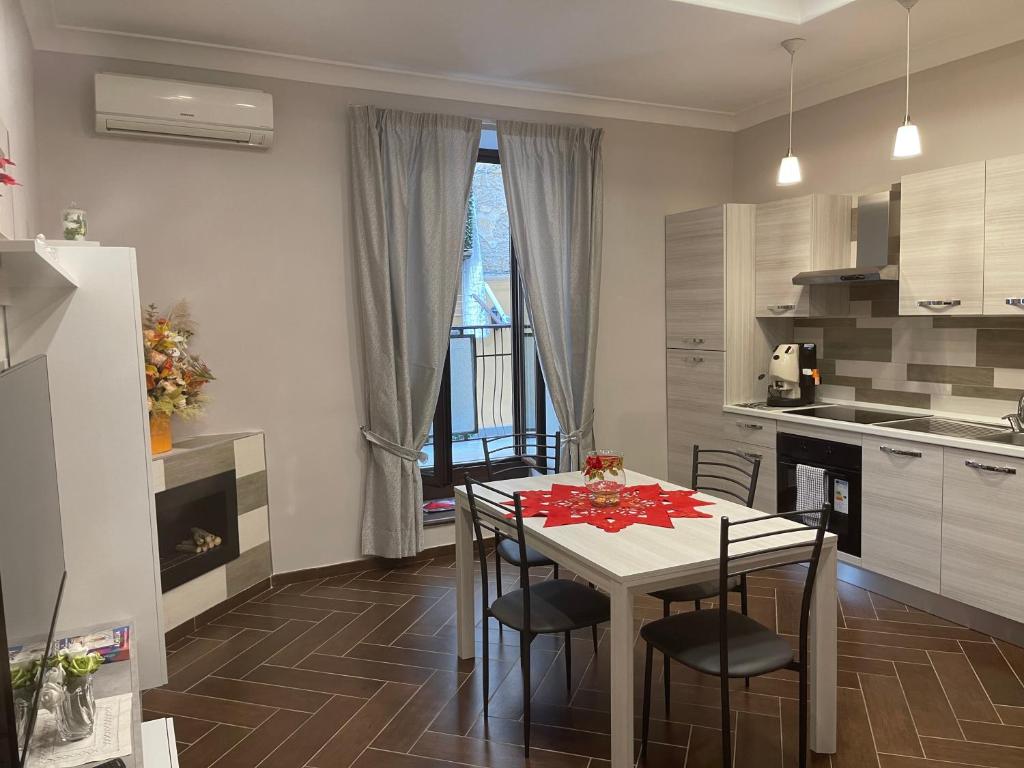 a kitchen and dining room with a table and chairs at Casa Meravigliosa Fonseca in Naples