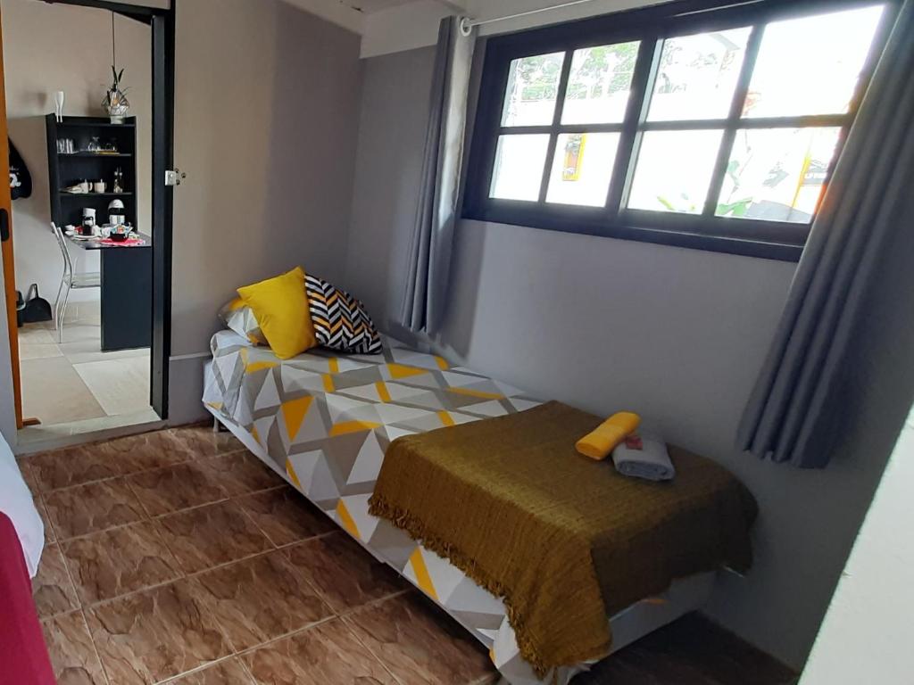 Villacasamarela mini casinhas de hospedes Rio vermelhoにあるベッド