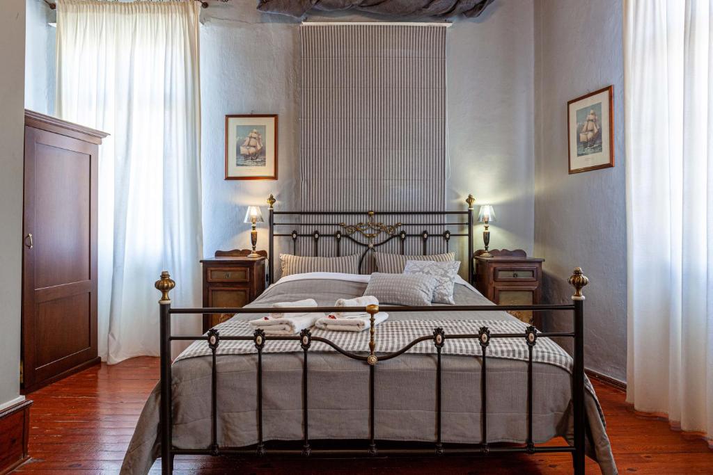 a bedroom with a bed with a metal frame at Althaia Pension in Nafplio