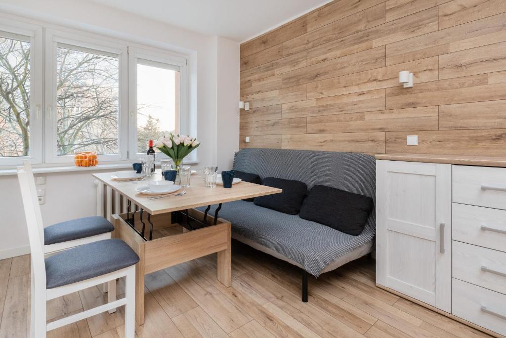 a dining room with a table and a bench at Cozy studio in Downtown Gdańsk by Renters in Gdańsk