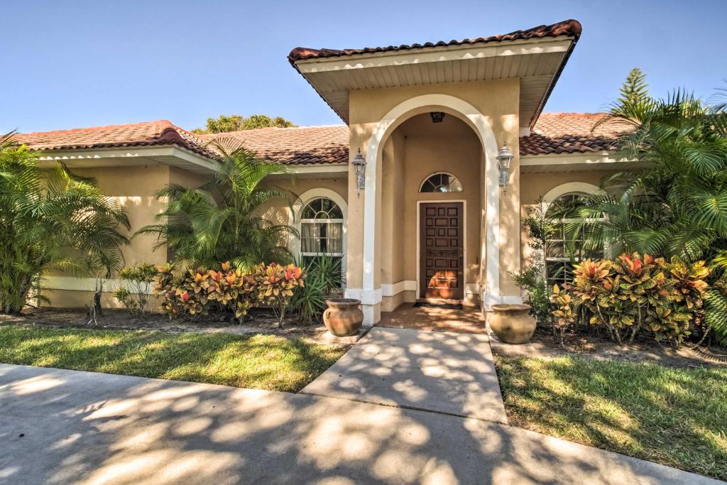a house with a pathway leading to the front door at Pet-Friendly Home in Vero Beach, 1 Mi to Beach! in Vero Beach