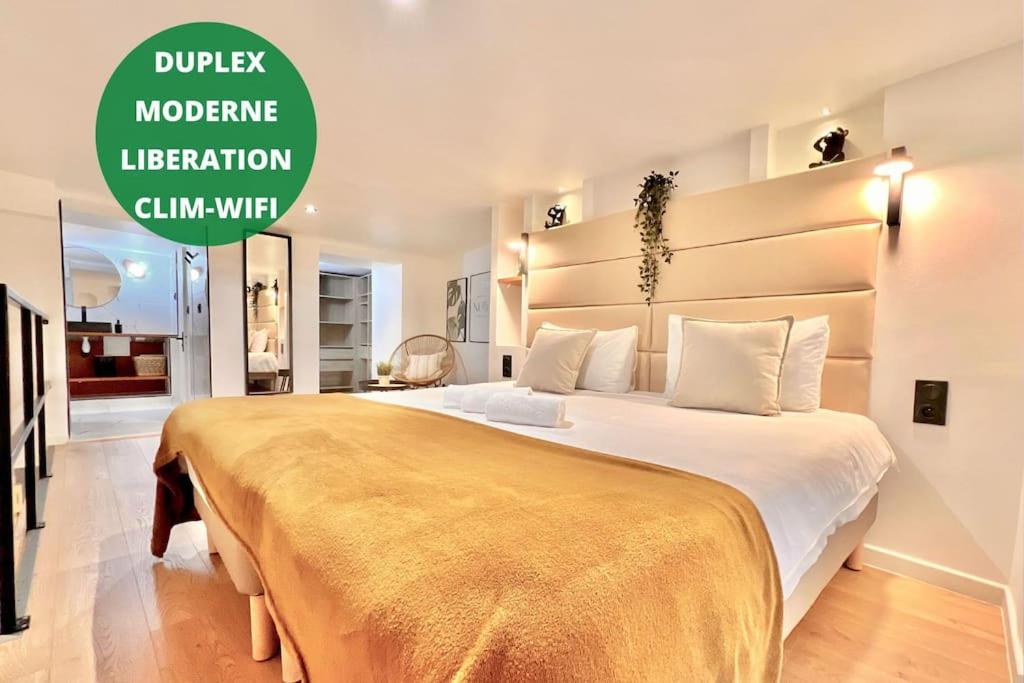 une chambre avec un grand lit avec une couverture jaune dans l'établissement * Duplex Roassal * Modern *Clim * WiFi *Liberation, à Nice