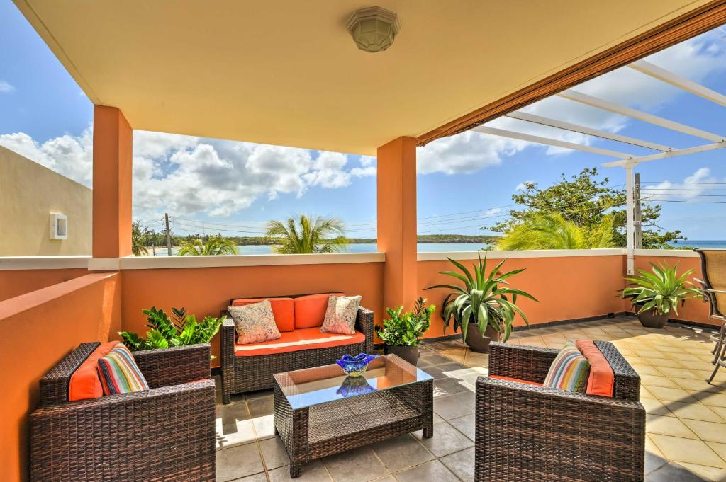 a patio with wicker chairs and a coffee table at Private Pool + Rooftop Views Near Seven Seas Beach in Fajardo