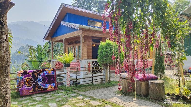 a house with a bunch of flowers in front of it at Eviana homestay in Darjeeling