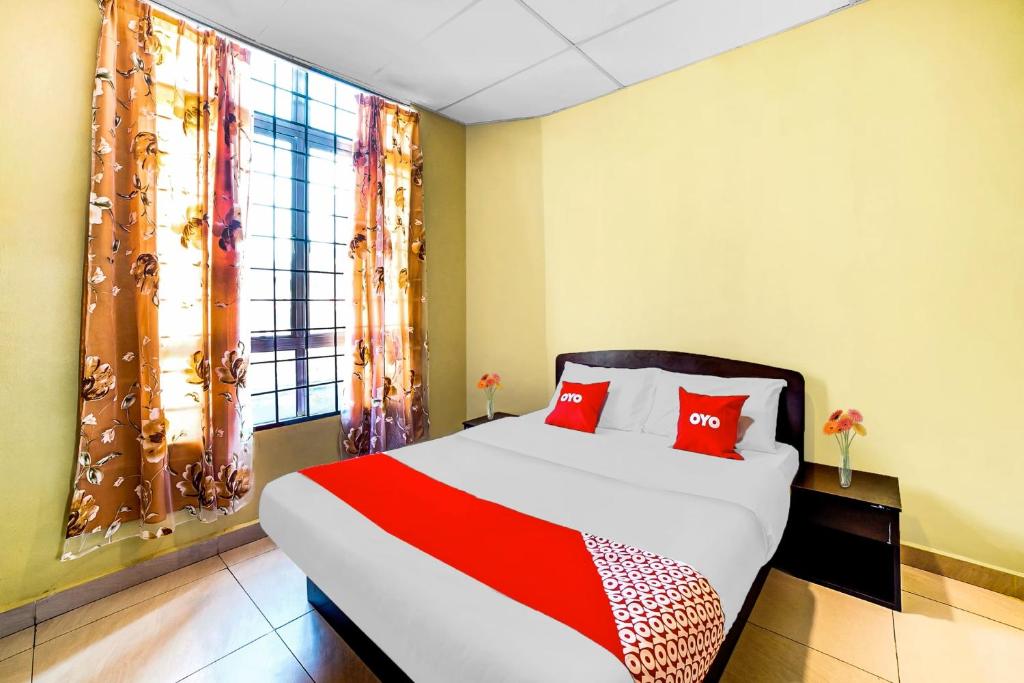 a bedroom with a large bed with red pillows at Hotel Lii View in Mersing