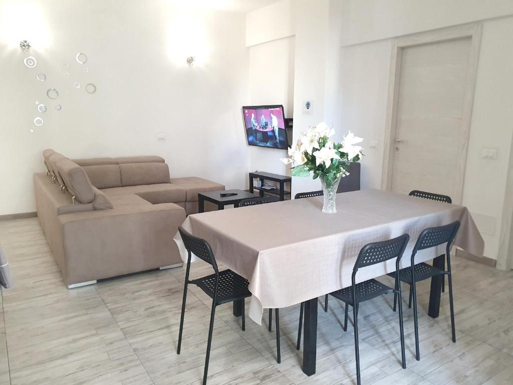a living room with a table and a couch at Savannah Charme Apartment in La Spezia