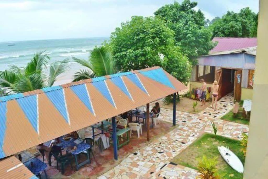 an overhead view of a restaurant with the ocean in the background at Kangaroo Pouch Beach Resort in Busua