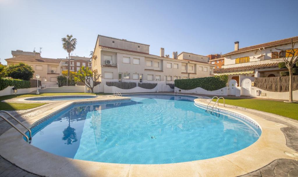 a large swimming pool in front of a building at R142 Manila Resort central in Calafell