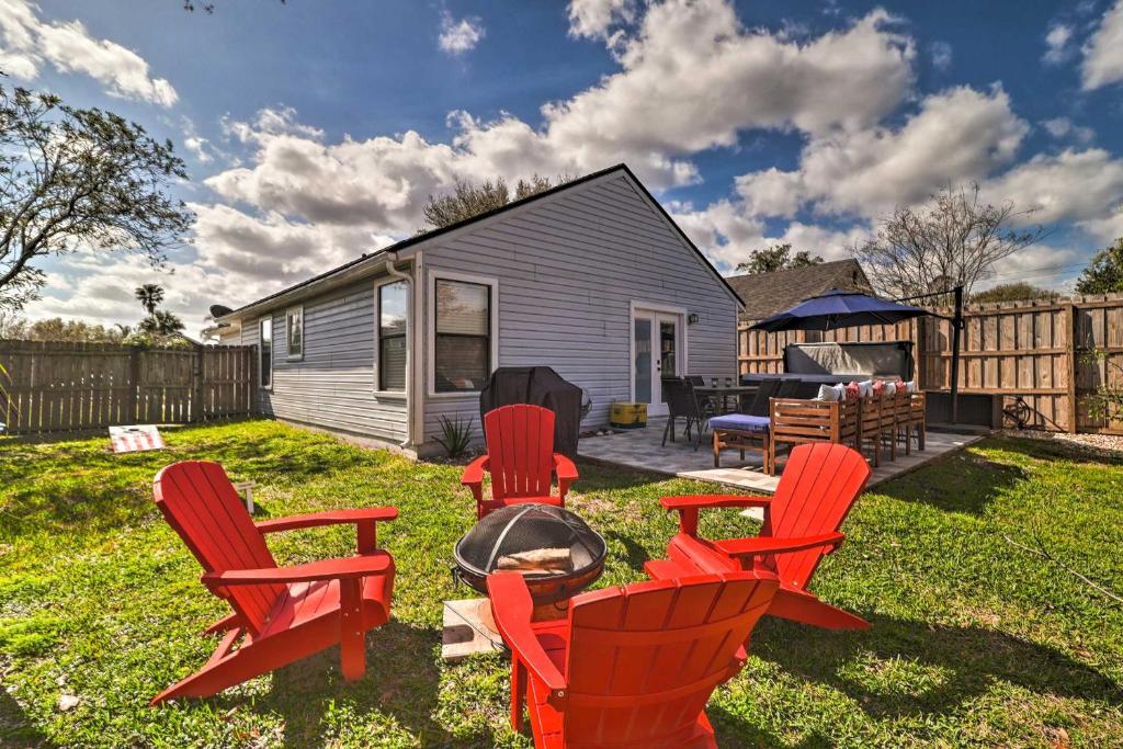 a backyard with red chairs and a fire pit at Casa Azul Modern Ponte Vedra Beach Bungalow in Ponte Vedra Beach