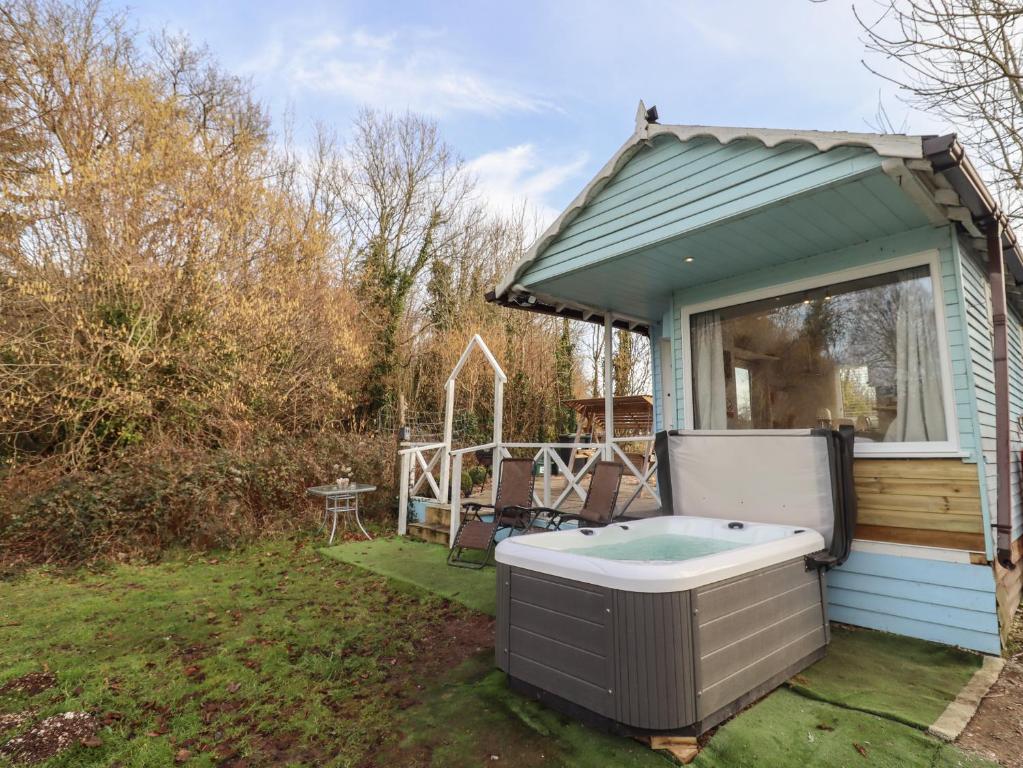 a hot tub in the backyard of a house at Art Studio in Blandford Forum