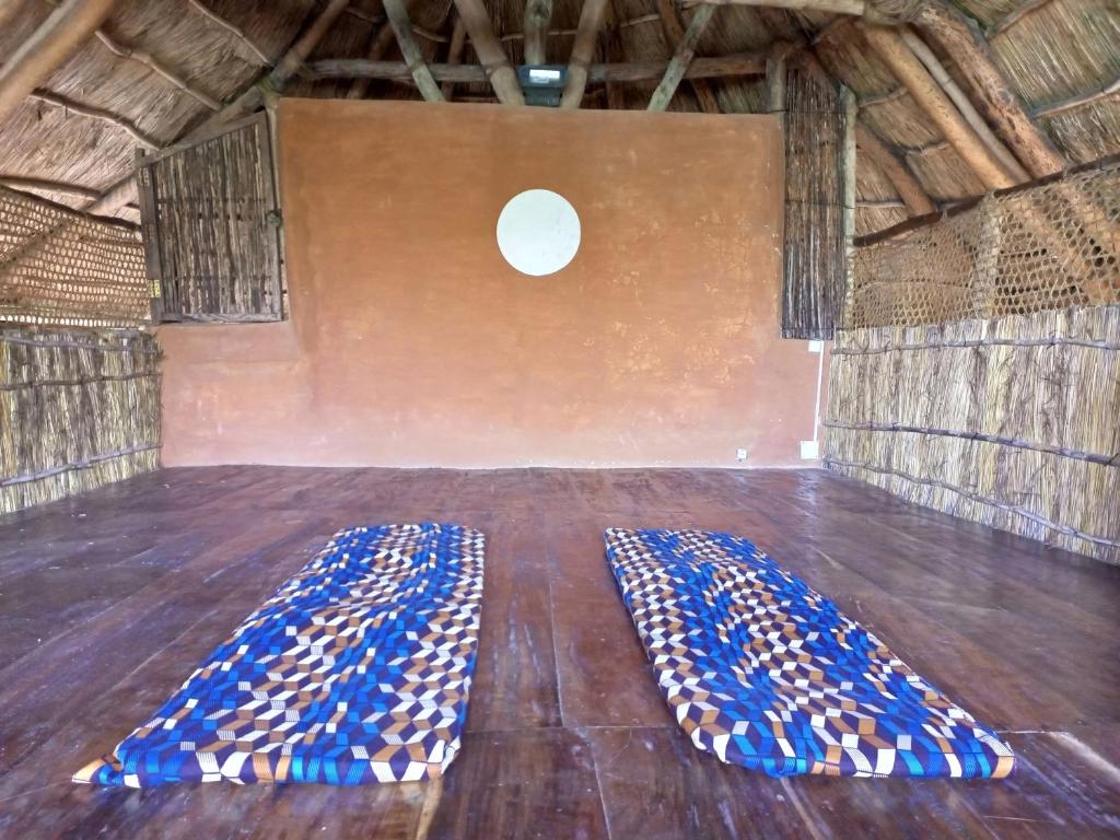 a room with two blue mats on a wooden floor at Belmoz Beach House in Chuca