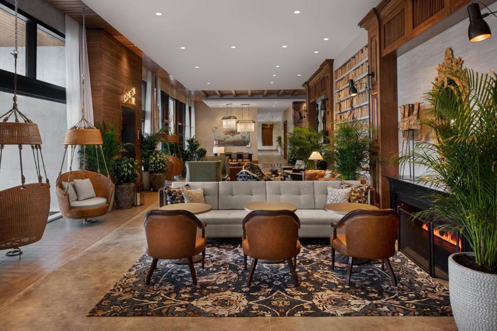 a living room with a couch and some chairs at The Ben, Autograph Collection in West Palm Beach