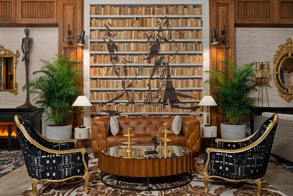 a living room with a couch and two chairs at The Ben, Autograph Collection in West Palm Beach