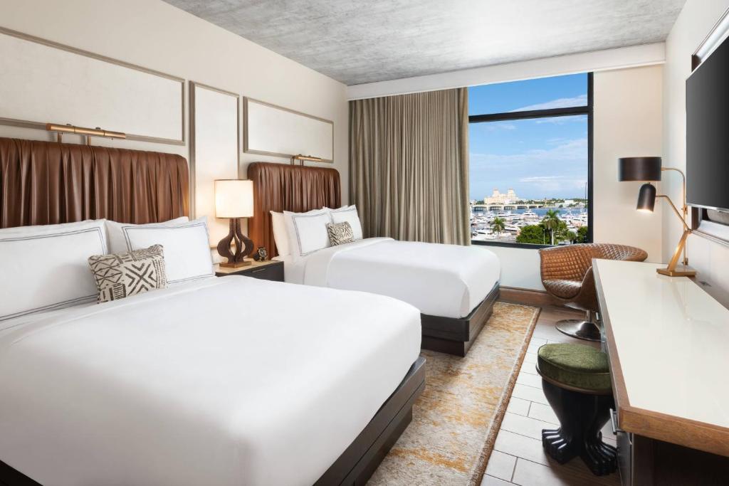a hotel room with two beds and a window at The Ben, Autograph Collection in West Palm Beach