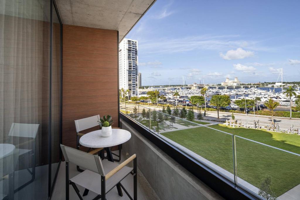 a balcony with a table and chairs and a view of a city at The Ben, Autograph Collection in West Palm Beach