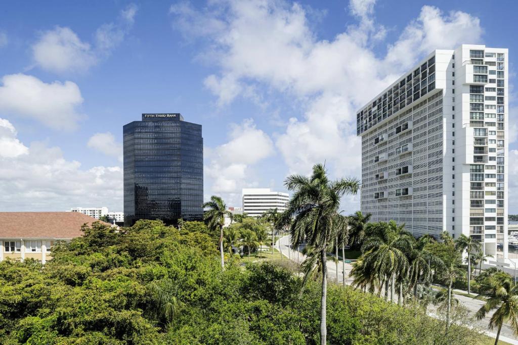 a city skyline with tall buildings and palm trees at The Ben, Autograph Collection in West Palm Beach