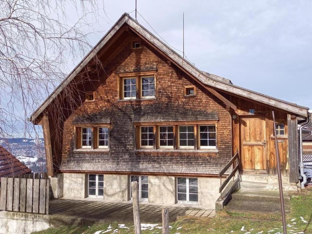 a large wooden house with windows on top at Ferienhaus, Stöckli Klingenbuch 20 in Rehetobel