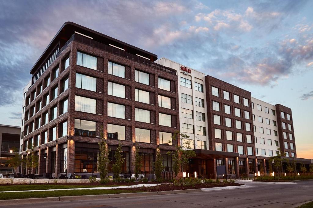 a large brick building on the side of a street at The Scarlet, Lincoln, a Tribute Portfolio Hotel in Lincoln