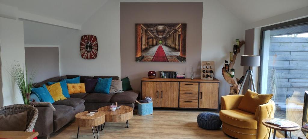 a living room with a couch and a table at LANDLOFT am Paradies in Westerstede