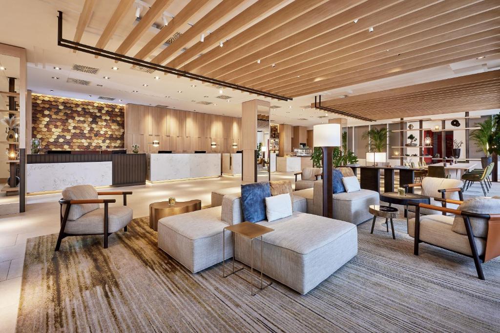 a lobby with couches and chairs and a bar at The Westin Grand Frankfurt in Frankfurt