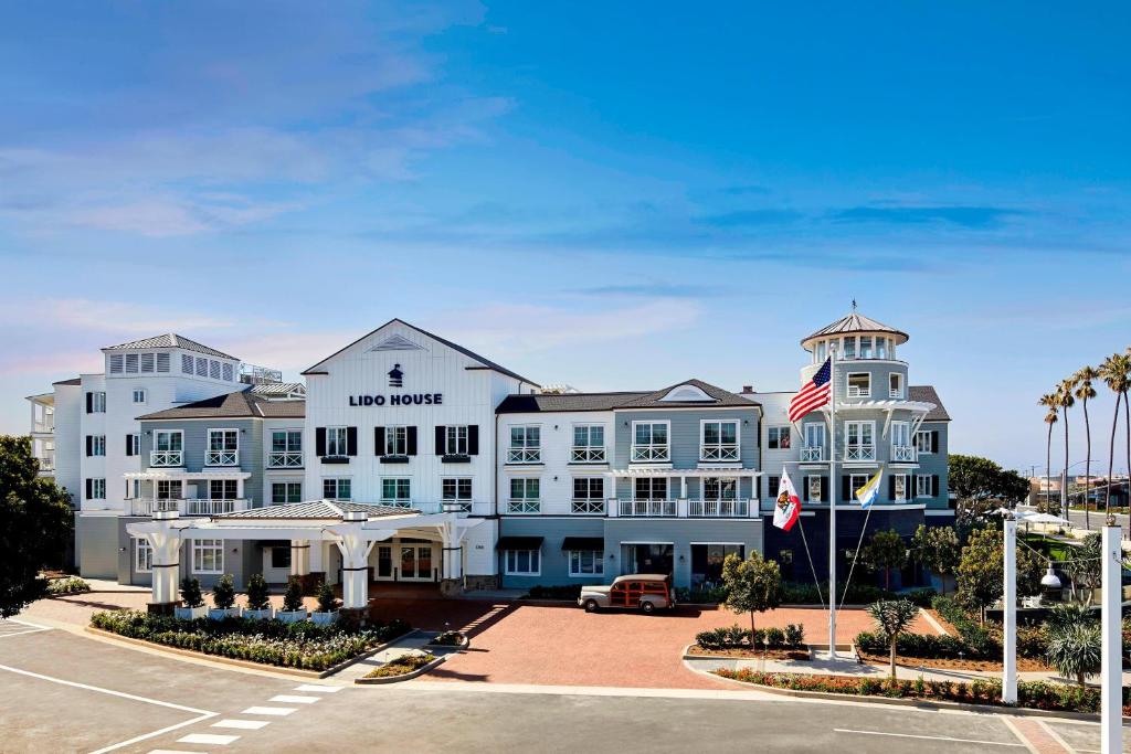 a large white building with an american flag at Lido House, Autograph Collection in Newport Beach
