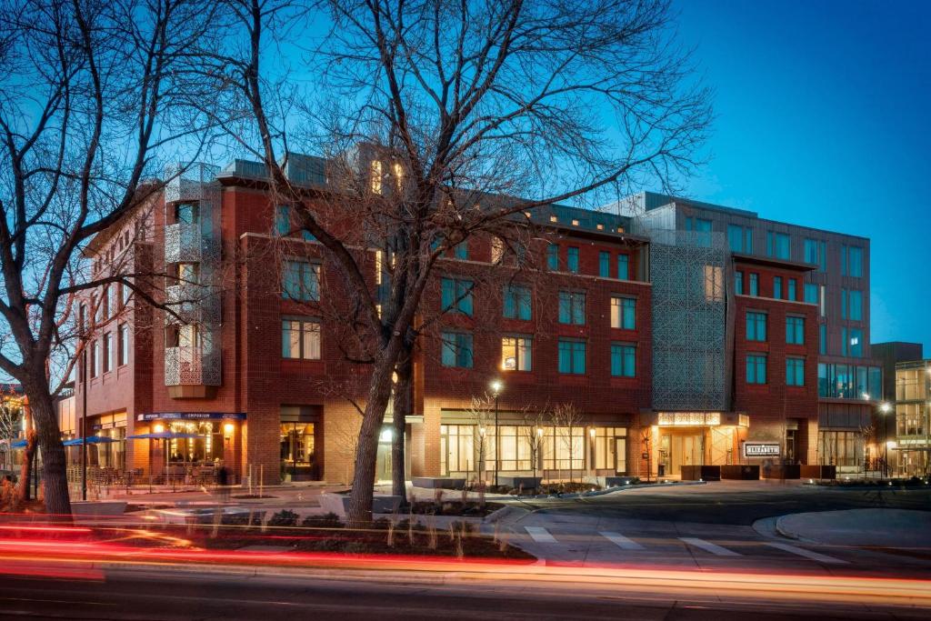 a building on a city street at night at The Elizabeth Hotel, Autograph Collection in Fort Collins