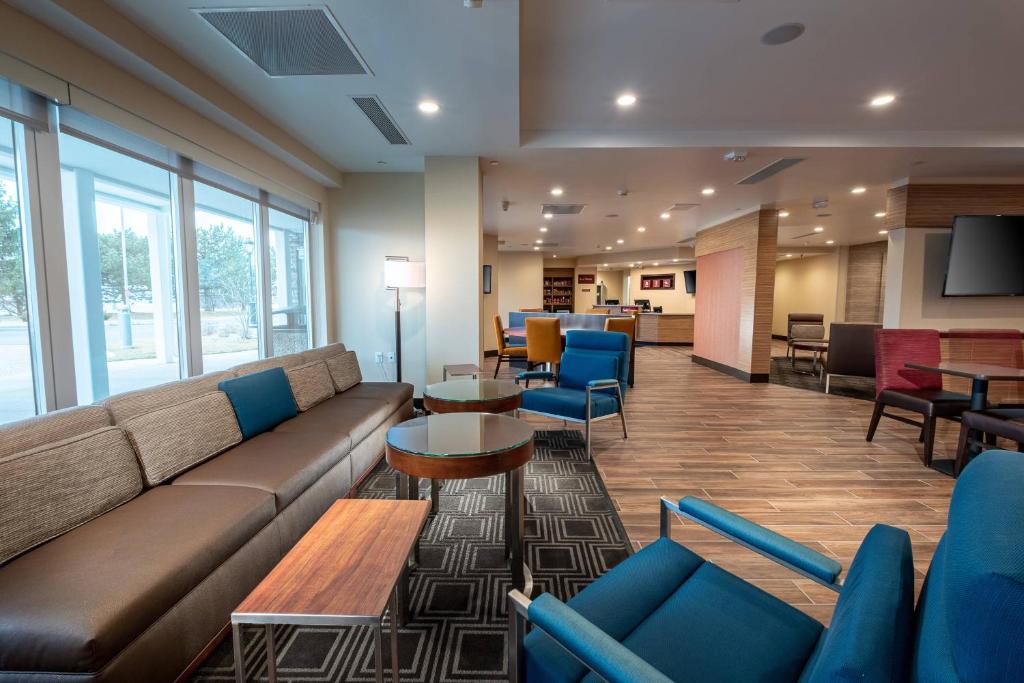 a lobby with a couch and tables and chairs at TownePlace Suites by Marriott Toledo Oregon in Oregon
