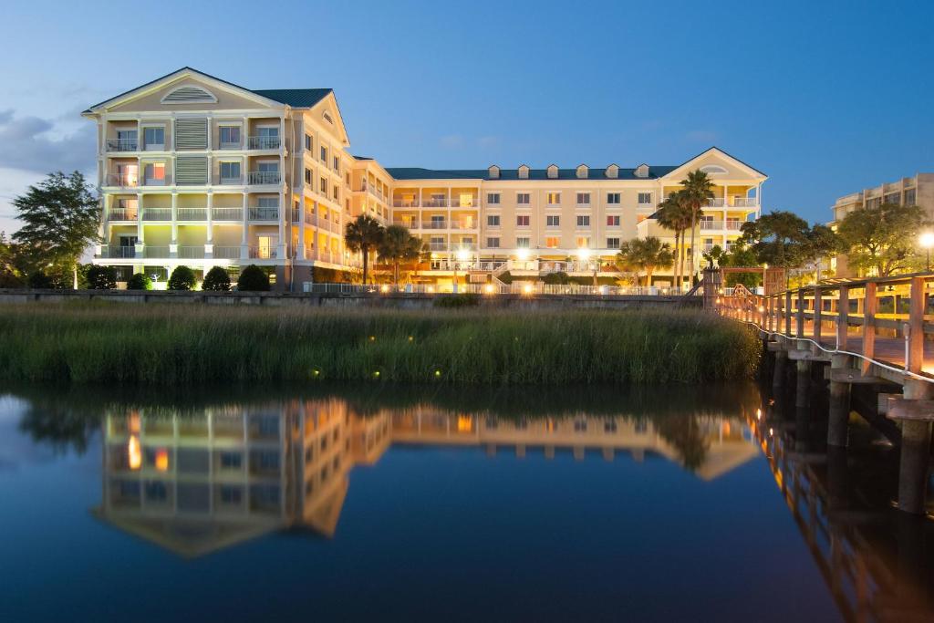 un edificio junto a un río por la noche en Courtyard Charleston Waterfront, en Charleston