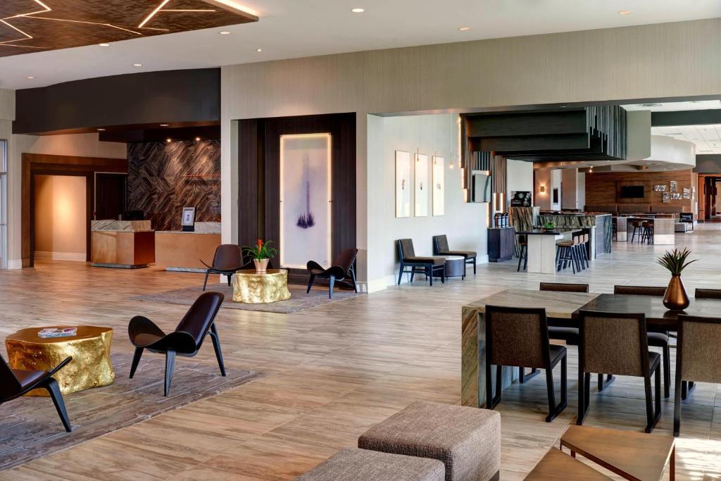 a lobby of a hotel with tables and chairs at Chicago Marriott Southwest at Burr Ridge in Burr Ridge