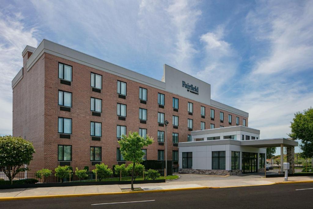 a large brick building with a sign on it at Fairfield Inn by Marriott JFK Airport in Queens