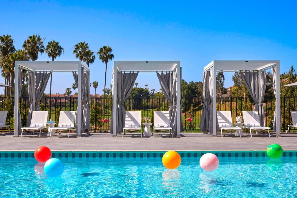 a swimming pool with colorful balls in the water at Westdrift Manhattan Beach, Autograph Collection in Manhattan Beach