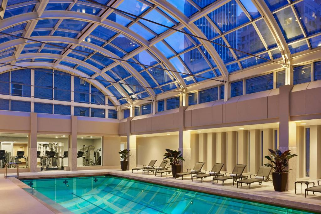 a large indoor pool with a glass ceiling at Palace Hotel, a Luxury Collection Hotel, San Francisco in San Francisco