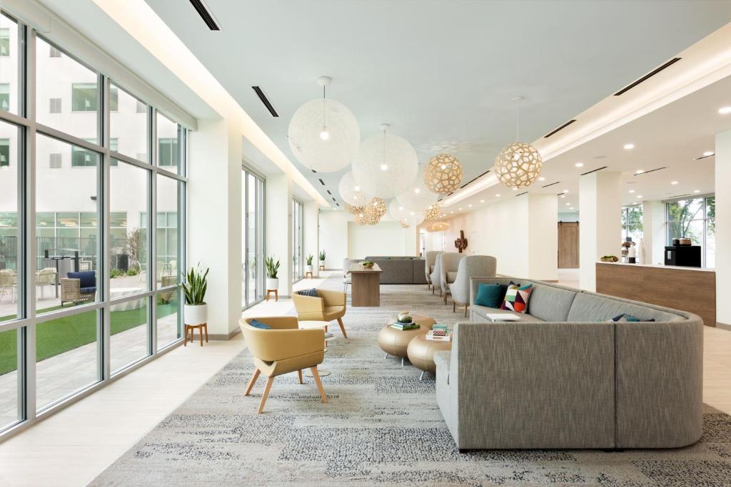 a lobby with couches and chairs and windows at Element Austin at The Domain in Austin