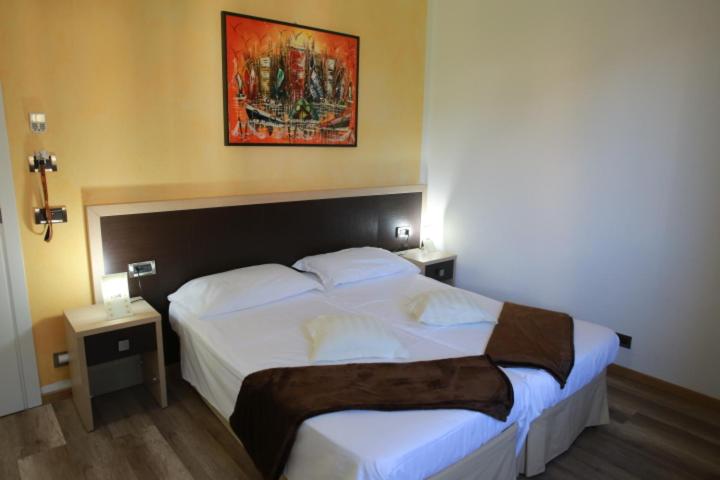 Postel nebo postele na pokoji v ubytování Hotel Lauro