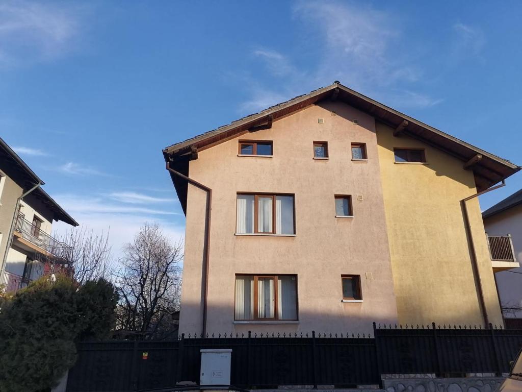 a building with a fence in front of it at Банско Апартментс in Bansko