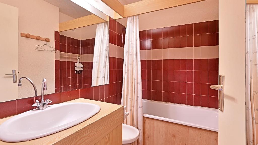 łazienka z umywalką, toaletą i lustrem w obiekcie Les Indes Galantes- 270E- Studio vue mer- 5 pers w Cap d'Agde