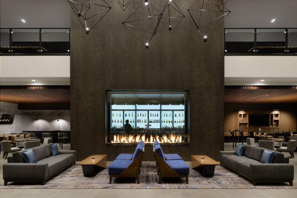 a lobby with couches and a fireplace and a bar at Marriott Tacoma Downtown in Tacoma