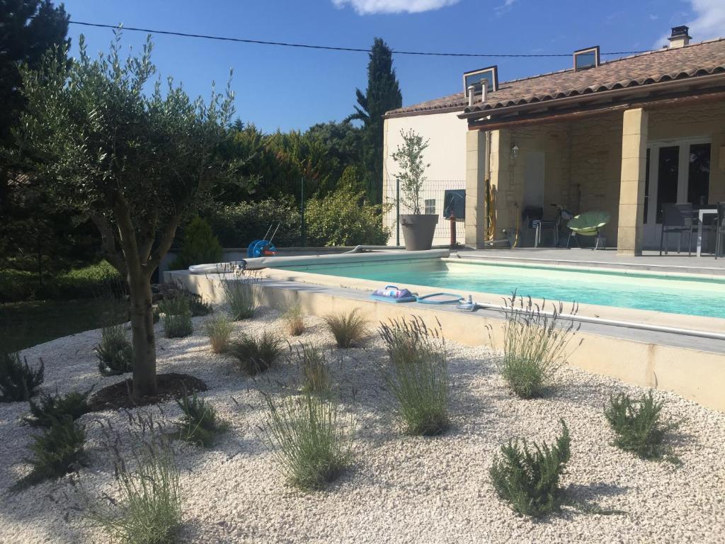 a villa with a swimming pool and a house at Villa Emma 10 &#47; 12 personnes in Grignan