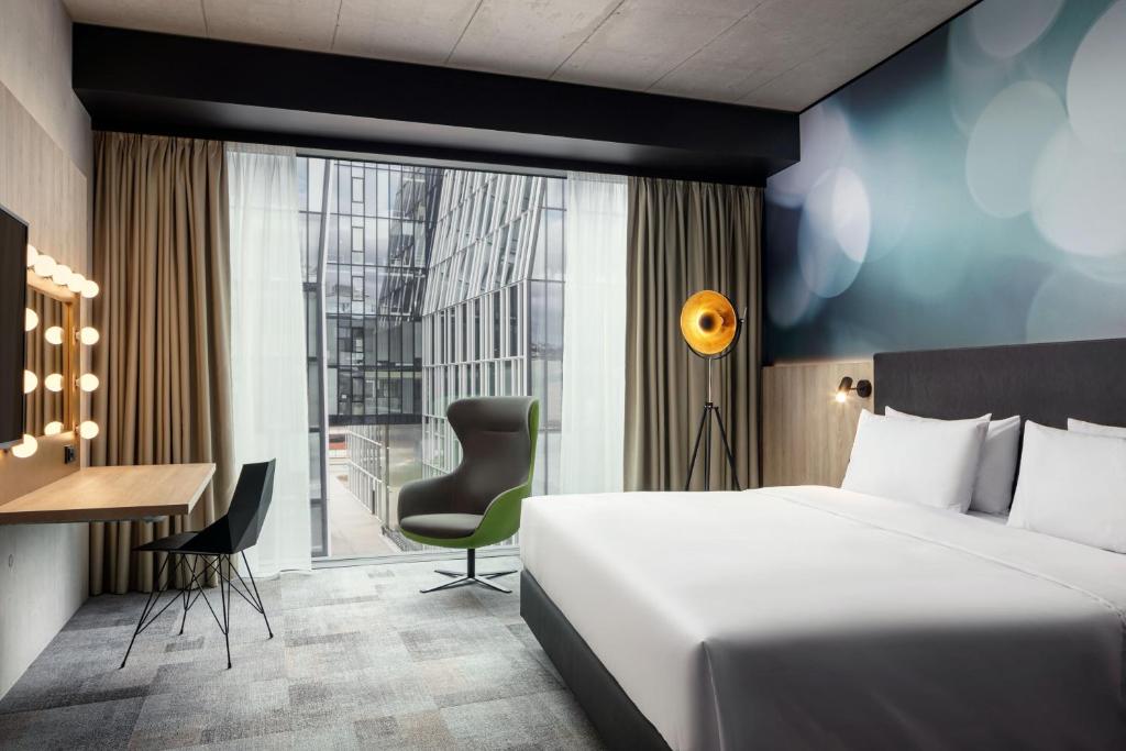 a hotel room with a bed and a desk at STAGES HOTEL Prague, a Tribute Portfolio Hotel in Prague