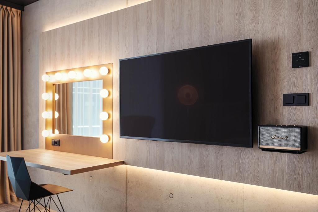 a flat screen tv hanging on a wall at STAGES HOTEL Prague, a Tribute Portfolio Hotel in Prague