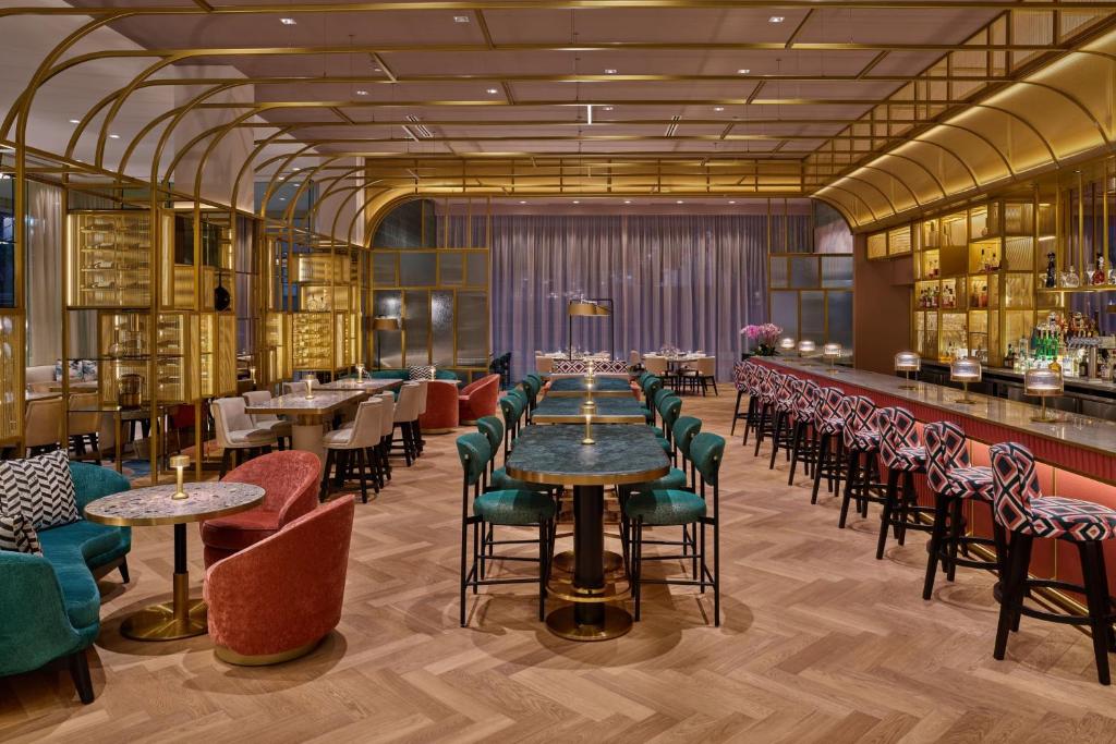 a restaurant with tables and chairs and a bar at The St. Regis San Francisco in San Francisco
