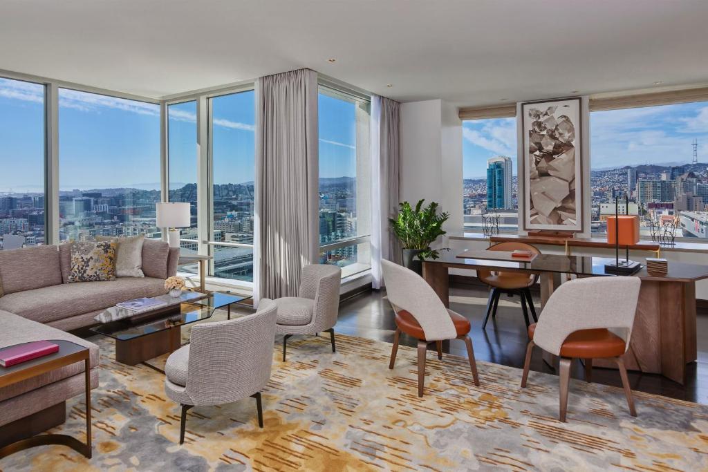 a living room with a couch and a table and chairs at The St. Regis San Francisco in San Francisco