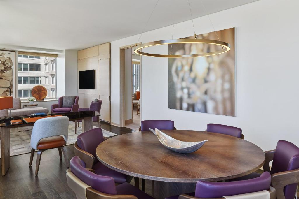 a dining room with a table and purple chairs at The St. Regis San Francisco in San Francisco