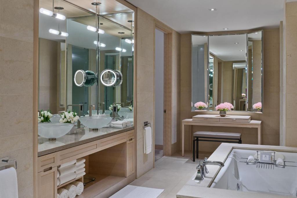 a bathroom with two sinks and a tub and mirrors at The St. Regis San Francisco in San Francisco