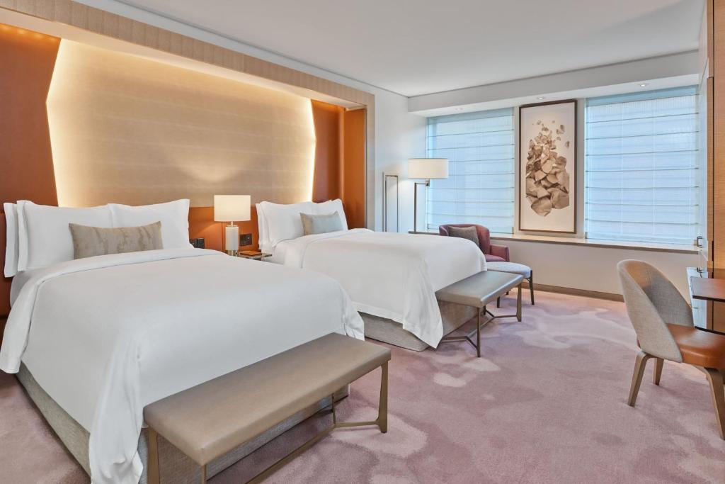 a hotel room with two beds and a desk at The St. Regis San Francisco in San Francisco