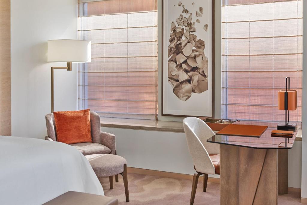 a room with a desk and two chairs and a table at The St. Regis San Francisco in San Francisco